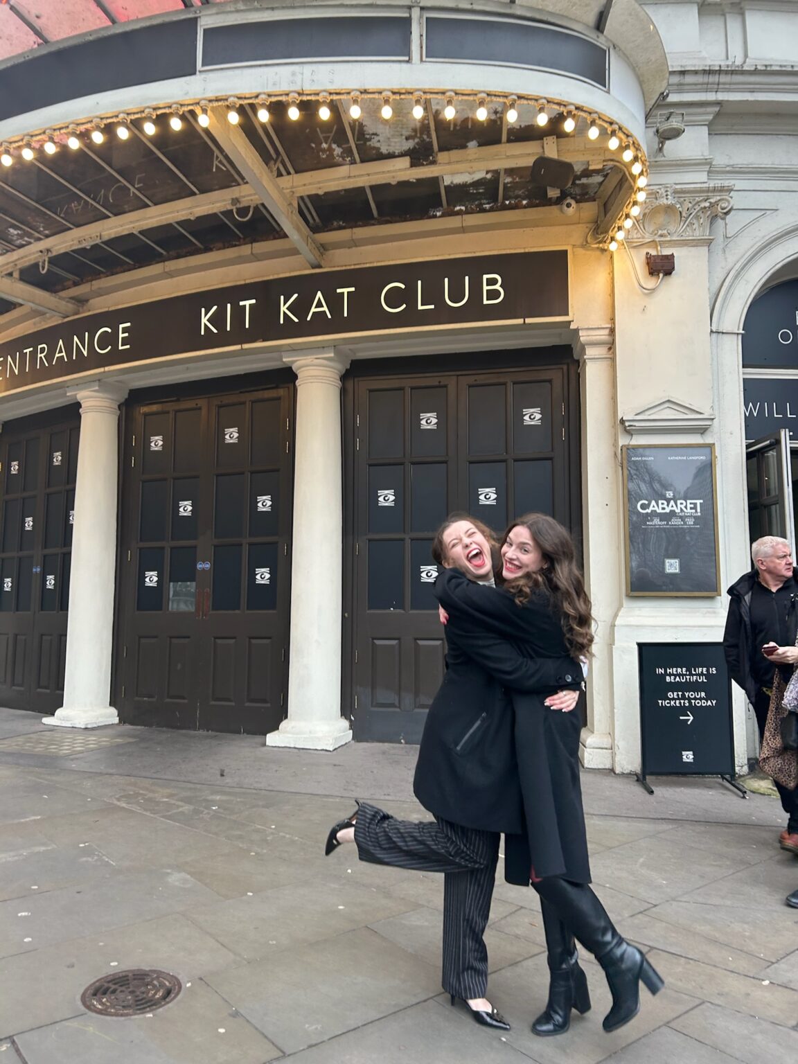 Sydney Anderson and Olivia Blank outside the Kit Kat Club where Cabaret is showing.