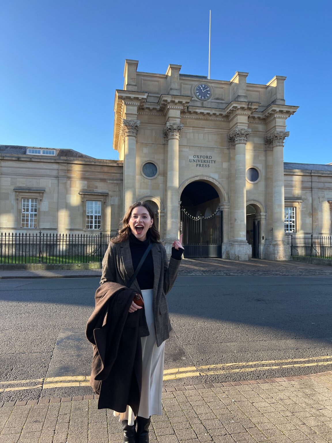 Olivia Blank points to the Oxford University Press building